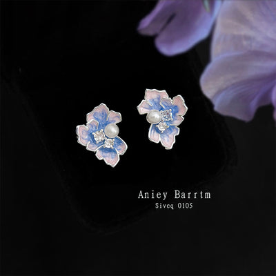 Silver-tone blue-purple-iris pearl studs in the first product display.