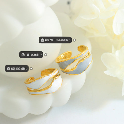 Blue and white enamel open rings on display with size and plating labels