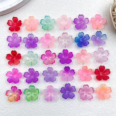 Colorful cherry blossom charms arranged on a light background