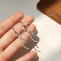 Gold Tone Crystal And Pearl Cross Twist Drop Earrings view 3