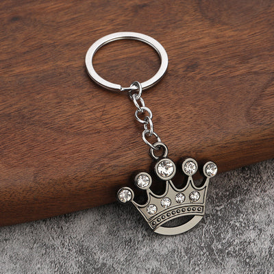 The ornate crown keychain is shown face up with its split ring and short chain.