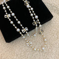 Black and White Bow Charm Long Pearl Strand Necklace view 4
