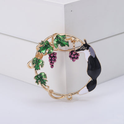 Product display showing a curled fox resting inside a gold-tone grapevine wreath