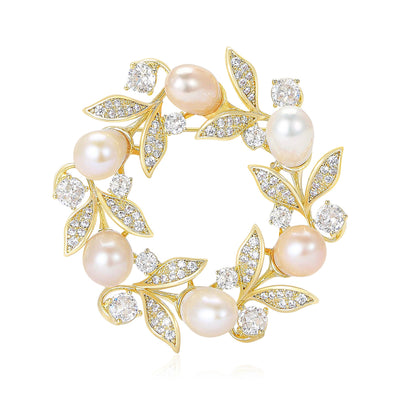 Front view of a gold-tone wreath of white pearls and pastel crystal leaves