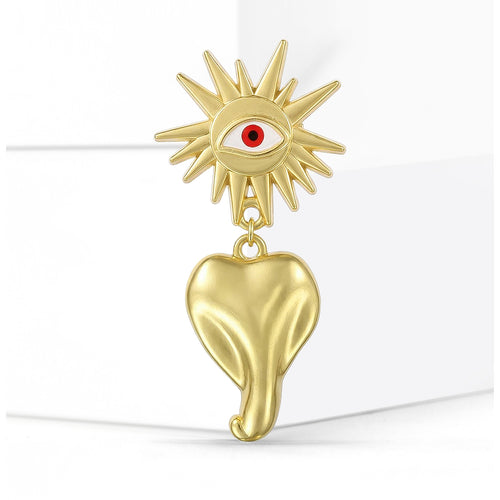 Gold Tone Sun Eye brooch With Red Eye And Heart Drop shown in styled product arrangement
