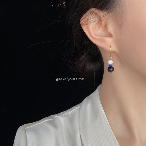 Gold white and blue bead drop earring worn on ear side profile