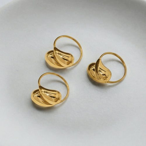 Display view of sculptural double teardrop open ring in main image 2.