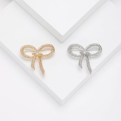 Front view of minimal open bow silhouette with a lightly textured surface