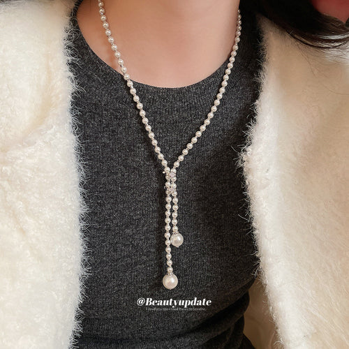 white pearl look necklaces in three beaded designs shown in the main product view