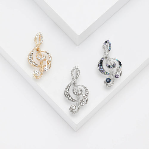 Front view of the crystal treble clef brooch and its color options