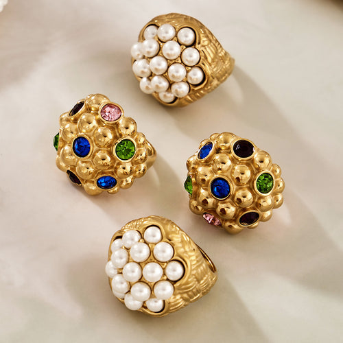 Styled hand view of oversized pearl and gemstone cluster rings in main image 1.