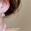 Gold Tone Flower Huggie Earrings with Crystal Petals view 3
