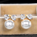 Gold Tone Bow and Pearl Look Stud Earrings Jewelry Pair view 2