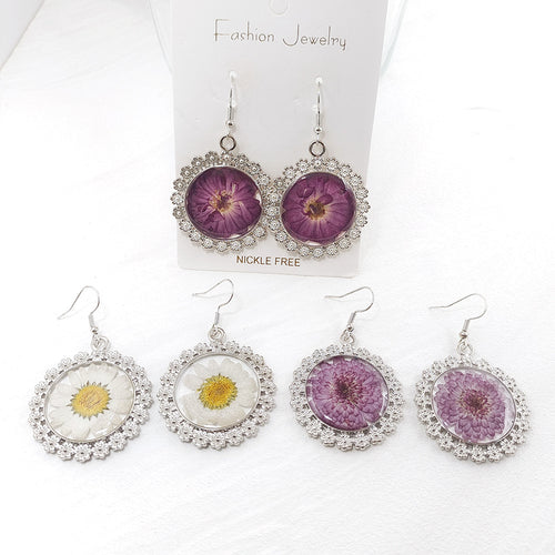 Assorted pressed flower resin earrings with lace rims on Fashion Jewelry card