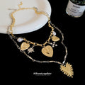Layered Gold Tone Heart Necklace with Celestial Charms view 2