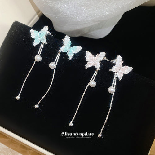 Styled view of gradient butterfly earrings with long crystal bead tassels