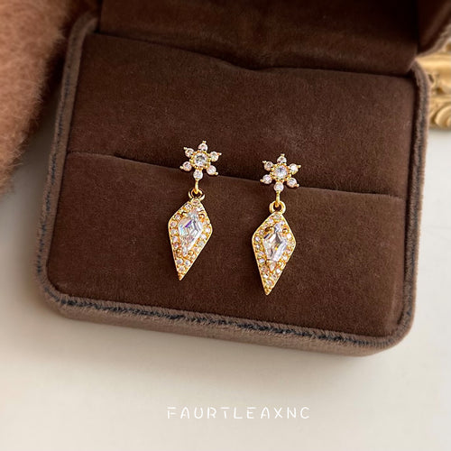 Gold snowflake kite crystal drop earrings in open brown velvet box