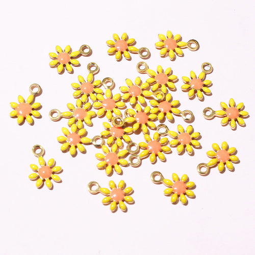 Tiny daisy charms arranged to show surface details