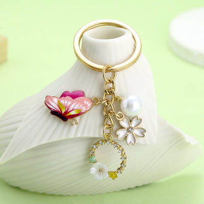 Image 1 showing a white vase with flowers and pearls on it.
