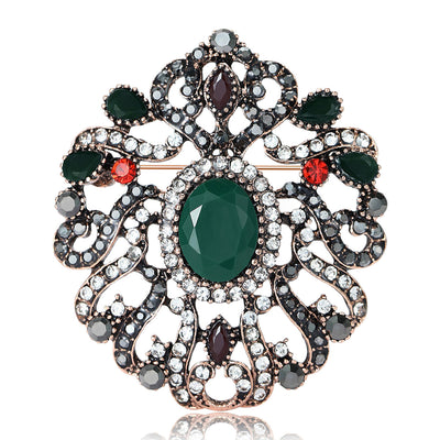 Antique copper openwork flower brooch with green oval center stone