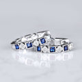 Silver Tone Hoop Earrings With Alternating Blue and Clear Stones view 2