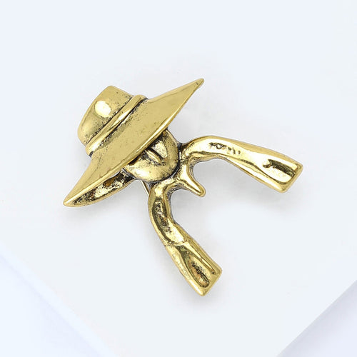 Angled view showing the wide brim hat figure brooch surface