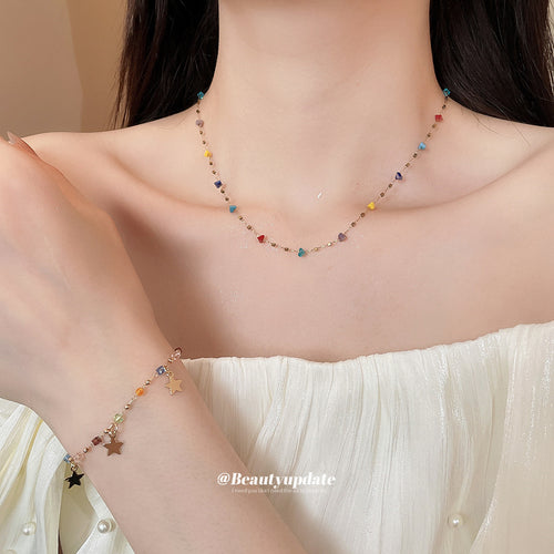 Multicolor crystal station necklace and star charm bracelet worn together