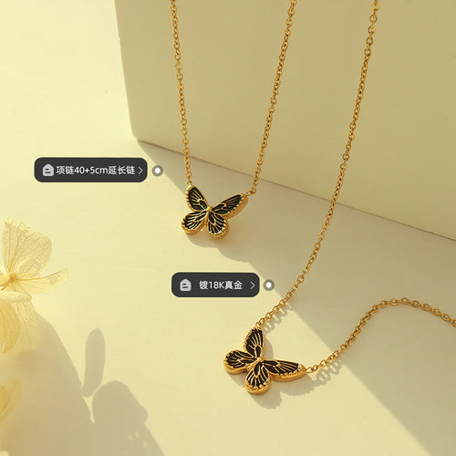 Two gold black-wing butterfly necklaces flat lay with length and plating tags
