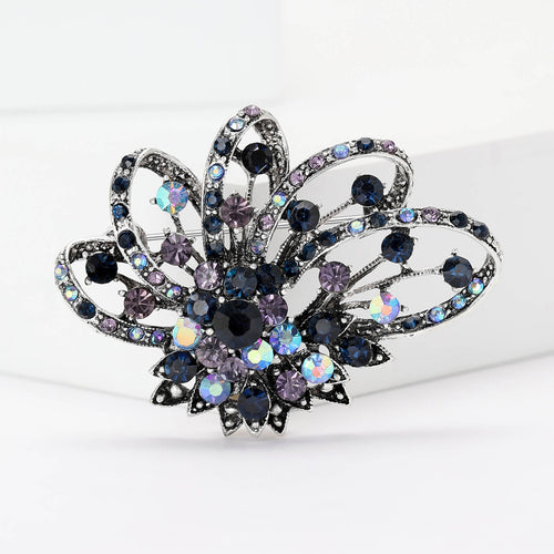 Blue purple crystal openwork flower brooch front on white