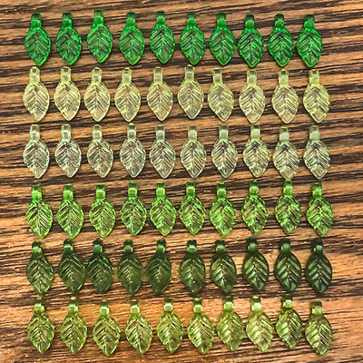 Clear leaf beads arranged on a light background