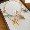 Gold Tone Sea Life Charm Necklace in Two Colorways view 7