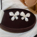 White Floral Shell Look Stud Earrings in Two Sizes view 7