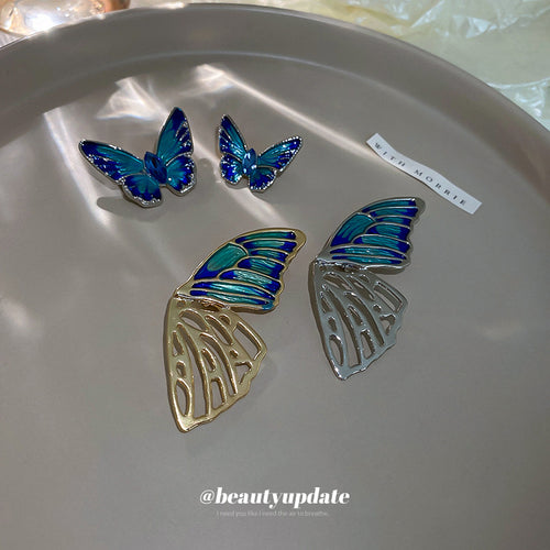 blue-green enamel butterfly brooch in two sizes shown worn in a styled second view