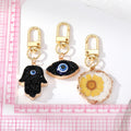 Gold Tone Druzy Style Hamsa Evil Eye and Pressed Flower Clip Keychains view 5