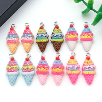 Multicolor strawberry and ice cream charms arranged on a light background