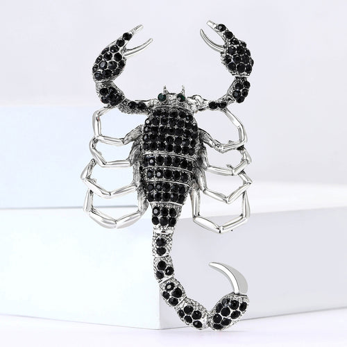 Pink rhinestone scorpion brooch close-up
