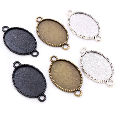 Image 1 showing oval double-loop pendant bezel settings in three finishes in the pictured colors and forms