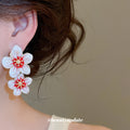 White Triple Flower Stud Earrings with Red Centers view 3
