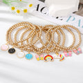 Gold Tone Beaded Smiley Butterfly Unicorn and Rainbow Bracelets view 1