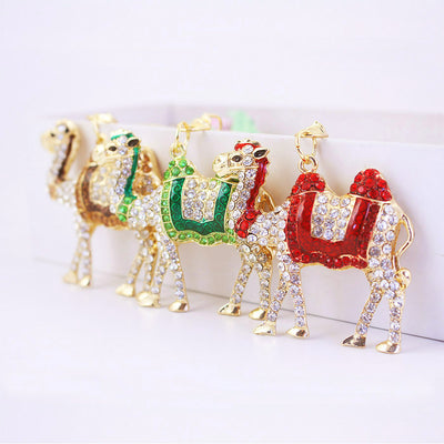 Red, green, and brown rhinestone camel ornaments stand side by side.