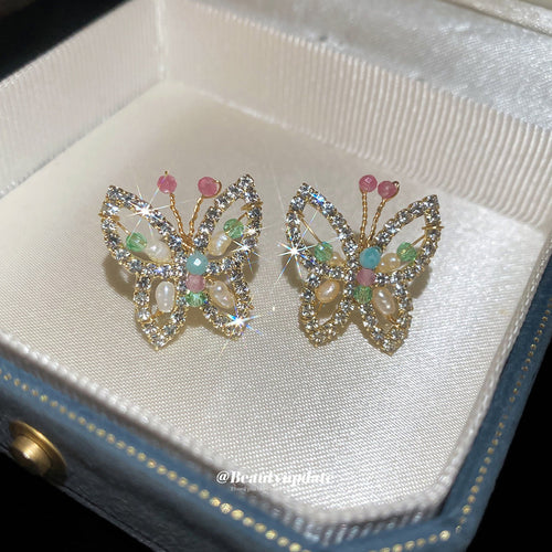 Pastel Crystal Butterfly Stud Earrings With Gold Tone Frames shown in worn view