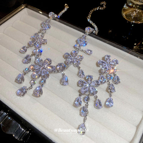 silver-tone flower crystal necklace and earrings with teardrop fringe shown worn in a styled second view