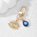 Gold Tone Open Lash Eye and Blue Evil Eye Clip Keychains view 7
