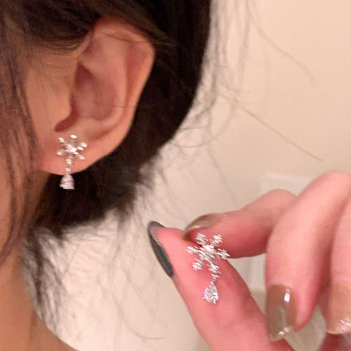 silver tone snowflake crystal stud earrings shown in a clear product view