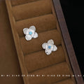 Silver Brushed Flower Stud Earrings Blue Center Stone view 4