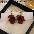 Gold Shell Top and Burgundy Petal Cluster Earrings view 1