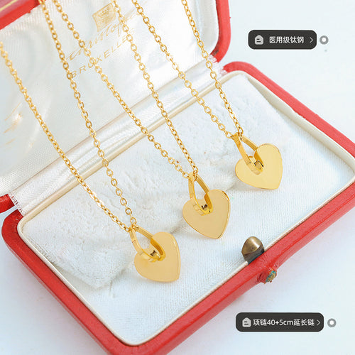 Three gold hollow heart necklaces in red box with size labels
