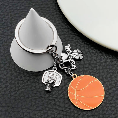 Front display of orange basketball enamel keychain with hoop charms with visible colors and attached hardware