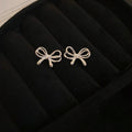 Minimal Bow Stud Earrings in Gold Tone or Silver Tone view 7