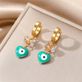 Gold Tone Bow and Heart Evil Eye Huggie Drop Earrings view 2
